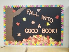 a bulletin board with fall into a good book written on it