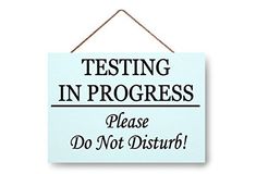 a sign that says testing in progress please do not disturb