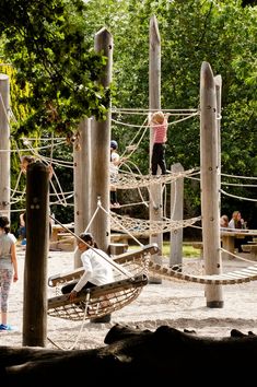 children playing on ropes in an outdoor play area