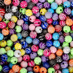 many different colored beads are stacked together