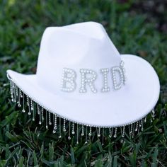 a white hat with the word brid written on it sitting in some green grass