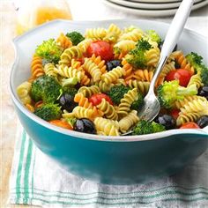 colorful spiral pasta salad recipe with broccoli and olives in a blue bowl