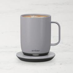 a cup of coffee sitting on top of a saucer next to a white counter