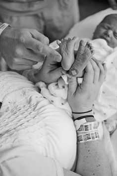 a person holding a baby in their hands