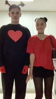 a man and woman are dressed up in costumes that look like they have hearts on them