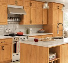 a kitchen with wooden cabinets and white counter tops