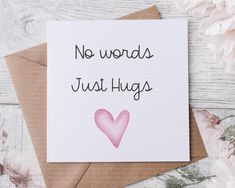 a card that says no words just hugs with a pink heart on it next to some flowers