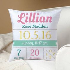 a personalized birth pillow on a white chair