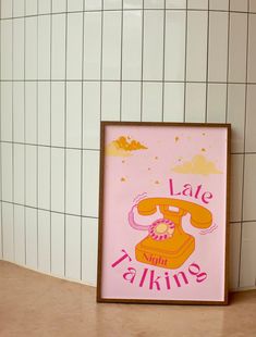 a pink poster with the words late talkin'on it next to a white tiled wall