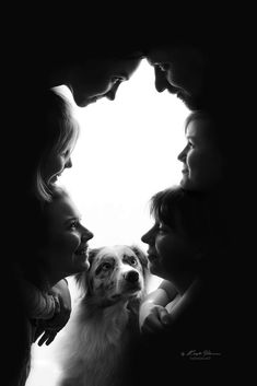 a group of people and a dog looking at each other