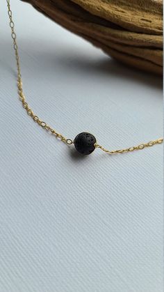 "Pele's Choker Necklace You can customize this black lava necklace to suit your personal style with your choice of sterling silver, 14k gold filled or 14k rose gold filled material. The model is wearing the 15\" length chain. D E T A I L S * Lava Bead Size: Approx 8mm * Chain Length: 14\" to 20\" For use with essential oils, add a drop or two of your favorite 100% pure therapeutic grade essential oil on to the lava beads, allow it soak in and enjoy the aromatherapy! Lava rocks are very porous an Everyday Spiritual Lava Stone Jewelry, Adjustable Hypoallergenic Black Necklace, Minimalist Adjustable Lava Stone Jewelry, Black Lava Stone Necklace For Gift, Elegant Adjustable Lava Stone Jewelry, Adjustable Black Minimalist Charm Necklace, Black Adjustable Minimalist Charm Necklace, Black Hypoallergenic Necklace As A Gift, Black Hypoallergenic Necklace For Gift