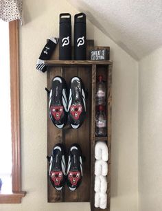 a wooden shelf with shoes and other items on it in the corner of a room