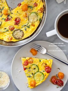 an omelet with zucchini, tomatoes and other toppings on a plate next to a cup of coffee