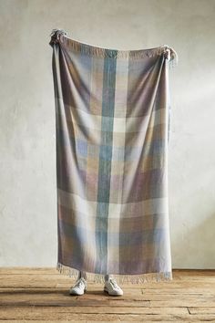 a plaid blanket draped over a wooden floor