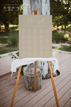 an easel with a sign on it that says the wedding date is written in cursive writing