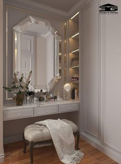 a dressing room with a stool, mirror and lights on the wall next to it