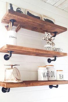 two wooden shelves with coffee mugs and teapots on them, hanging from the ceiling