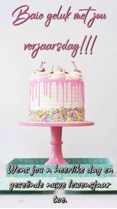 a birthday cake with pink icing and sprinkles on it is displayed