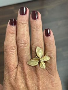 This exquisite 18K solid yellow gold ring features a unique butterfly design, with matte-finished wings carved in the shape of leaves for a stunning and intricate detail. Measuring 1" in length, this beautiful lady's ring is truly a work of art and a conversation piece. Its exceptional craftsmanship and distinctiveness make it an excellent choice for anyone seeking a striking and unique piece of jewelry. Ring size 7 Luxury Gold Butterfly-shaped Ring, Luxury Gold Butterfly Ring, Gold Formal Butterfly Ring, Gold Formal Rings With Nature-inspired Style, Gold Butterfly Ring For Wedding, Gold Nature-inspired Rings For Formal Occasions, Formal Yellow Gold Butterfly Ring, Formal Yellow Gold Butterfly-shaped Ring, Yellow Gold Butterfly Ring For Formal Occasions