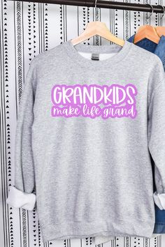 a gray sweatshirt with pink lettering that says grandkids make life grand on it