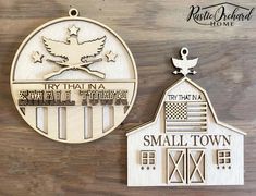 two wooden plaques depicting small towns and the american flag