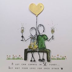 a couple sitting on a bench holding champagne glasses with a heart shaped balloon above them