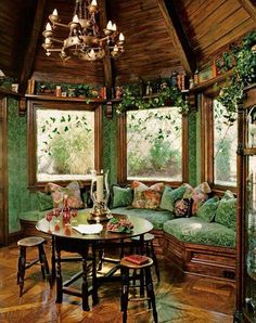 a living room filled with lots of furniture next to a window covered in ivy leaves