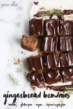 chocolate brownies with frosting and sprigs on top