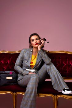 a woman sitting on top of a red couch