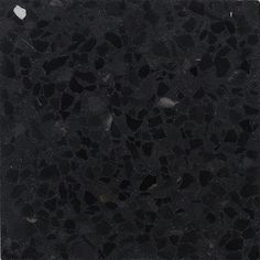 a black marble tile with small holes in the middle