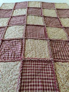 a red and white checkered blanket on top of a bed