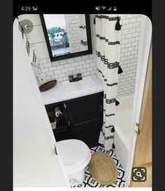 a small bathroom with black and white decor