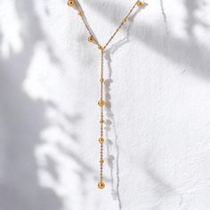 18k Gold Lariat Necklace, Long Beaded Chain Necklace, Silver Dainty Y Layered Necklace, Minimalist Drop Necklace, Gift for Her Introducing our 18k Gold Lariat Necklace designed with your comfort and style in mind.  Two styles available: Gold & Silver Lenght: 39cm + 5cm Drop: 9.5cm Weight: 4.9g  Why choose us? Meticulous Handcrafting * Luxurious 18K Gold-Plated Design * Water-Resistant and Fade-Proof * Hypoallergenic and Skin-Friendly  We value your time and satisfaction Lightning-Fast Order Processing * Reliable Shipping  All items are custom-made to order. Our turn around time is about 6 - 10 business days. This can change during peak seasons.  Your satisfaction is our top priority. Join our community of delighted customers and discover the joy of owning our exceptional creations! Minimalist Lariat Necklace With Satellite Chain, Lariat Necklaces With Satellite Chain For Gifts, Gold Lariat Necklace With Dangling Beads, Elegant Beaded Chain Lariat Necklace With Dangle, Adjustable Gold Lariat Necklace With Dangling Beads, Elegant Lariat Necklace With Beaded Dangle Chain, Elegant Lariat Necklace With Beaded Chain Dangle, Gold Lariat Necklace With Dangling Beads For Gifts, Dainty Beaded Lariat Necklace