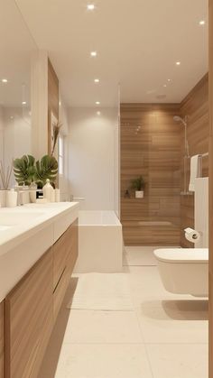 a bathroom with a toilet, sink and bathtub in the middle of it is illuminated by recessed lights