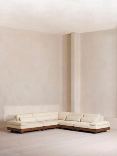 a large white couch sitting in the middle of a room