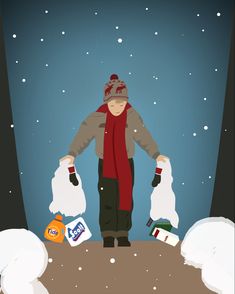 a man standing in the snow holding two bags