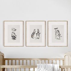 three framed pictures hang on the wall above a crib