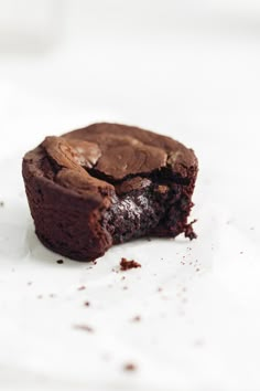 a half eaten brownie sitting on top of a white table