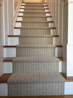 the stairs are lined with herringbone carpet