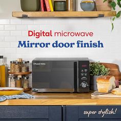 a microwave sitting on top of a wooden counter next to a shelf filled with food