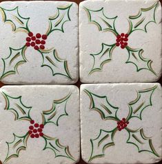 four white and green christmas holly coasters with red berries