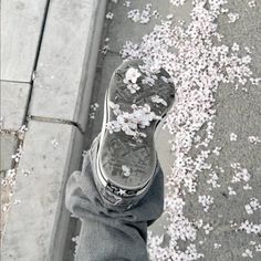 someone standing on the sidewalk with their feet covered in flowers