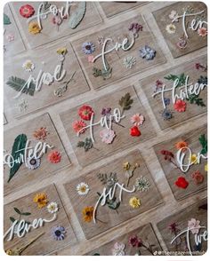 flowers are arranged in the shape of letters and numbers on wooden boards that spell out their names