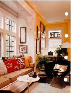 a living room filled with furniture and lots of windows