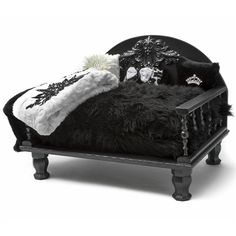 a black and white doll bed with pillows on it's back legs, made to look like an old fashioned daybed