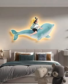 a child's bedroom with a bed, teddy bear and shark wall decal