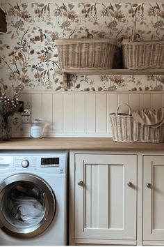 a washer and dryer in a room with floral wallpaper on the walls