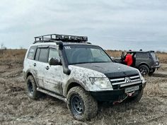 two vehicles parked in the middle of a field