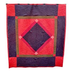 a purple and red quilt with squares on it