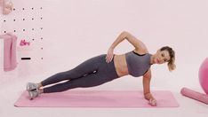 a woman in grey top and gray leggings doing exercises on pink exercise mat